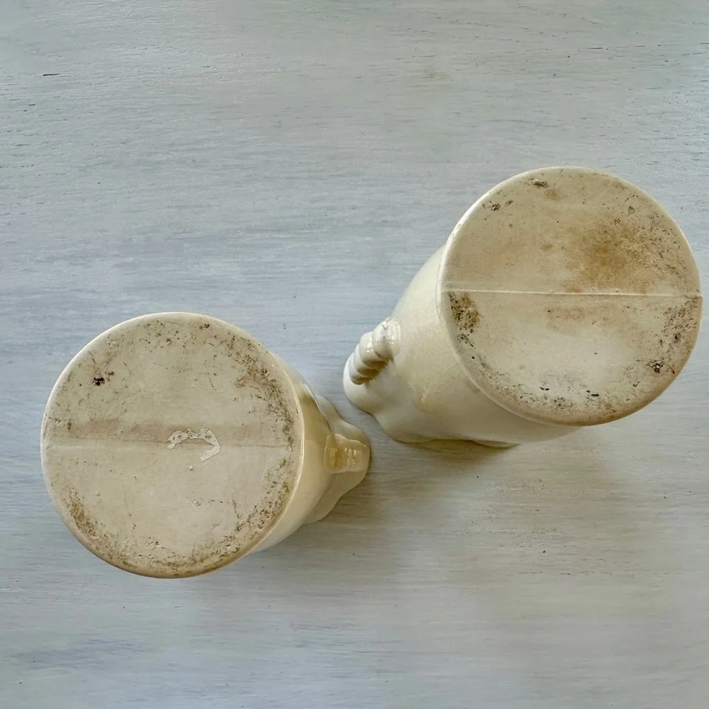1950’S SET/2 , FLORAL VASES. SOFT CREAM COLOR WITH ONE SIDED FLORAL DESIGN.